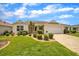 Charming single-story home featuring a well-manicured lawn and a two-car garage at 17567 Se 81St Parnassus Ct, The Villages, FL 32162