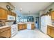 Functional kitchen with tile floors and white appliances, overlooking the living area at 17567 Se 81St Parnassus Ct, The Villages, FL 32162