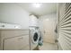 Bright laundry room featuring modern washer and dryer at 17567 Se 81St Parnassus Ct, The Villages, FL 32162