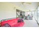 Enclosed sunroom with tile floors, comfortable seating, and a ceiling fan at 17567 Se 81St Parnassus Ct, The Villages, FL 32162