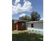 Backyard with a brick corner, solar panels and blue trim, great for sustainable living and outdoor enjoyment at 3439 Swindell Rd, Lakeland, FL 33810