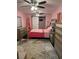Bright bedroom with pink walls, decorative rug, and stylish decor at 3439 Swindell Rd, Lakeland, FL 33810