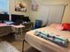 Bedroom featuring desk area, artwork and light ceiling fan at 3439 Swindell Rd, Lakeland, FL 33810