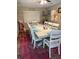 Bright dining room with a long white table, plenty of seating, and a pink accent rug at 3439 Swindell Rd, Lakeland, FL 33810