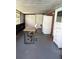 Enclosed patio featuring a desk, office chair, additional storage, and access to the outdoors at 3439 Swindell Rd, Lakeland, FL 33810