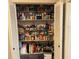 Pantry with white folding doors, stocked with various household items at 3439 Swindell Rd, Lakeland, FL 33810