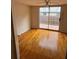 Cozy bedroom with wood floors and sliding glass door to backyard at 5418 Brownell St, Orlando, FL 32810