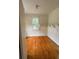 Small bedroom with wood floors, a window, and built-in shelving at 5418 Brownell St, Orlando, FL 32810