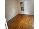 Cozy bedroom featuring hardwood floors and a sun-filled window at 5418 Brownell St, Orlando, FL 32810