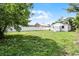 View of the backyard with a white fence and lush lawn at 1304 E Myrtle St, Lakeland, FL 33801