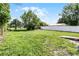 Expansive backyard with mature trees and a white fence at 1304 E Myrtle St, Lakeland, FL 33801