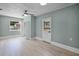 Bright bedroom with light wood floors, ceiling fan, and closet for ample storage at 1304 E Myrtle St, Lakeland, FL 33801
