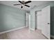 The light-filled bedroom has wood-look floors, a ceiling fan, and closet with easy access at 1304 E Myrtle St, Lakeland, FL 33801