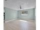 The bright bedroom boasts wood-look floors, neutral paint, a ceiling fan, and a window for natural light at 1304 E Myrtle St, Lakeland, FL 33801