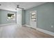 Bedroom boasts wood-look flooring, a ceiling fan, closet and door for easy access at 1304 E Myrtle St, Lakeland, FL 33801