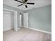 Bedroom with a ceiling fan, wood-look floors, a closet, and easy access to the en-suite bathroom at 1304 E Myrtle St, Lakeland, FL 33801