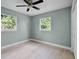 Light-filled bedroom features wood-look floors, neutral walls, a closet, and dual windows at 1304 E Myrtle St, Lakeland, FL 33801