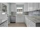Modern kitchen featuring white cabinets, granite countertops, and stainless steel appliances at 1304 E Myrtle St, Lakeland, FL 33801