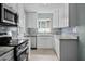 Contemporary kitchen with stainless steel appliances, granite counters, and light wood flooring at 1304 E Myrtle St, Lakeland, FL 33801