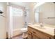 Bathroom featuring a tub-shower combination, a vanity and a neutral color scheme at 201 W New York Ave, Orange City, FL 32763