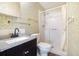 Bathroom featuring a new vanity and a walk-in shower with neutral, patterned wallpaper at 201 W New York Ave, Orange City, FL 32763