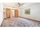Bright bedroom boasts a ceiling fan, ensuite bathroom, and natural light from the window at 201 W New York Ave, Orange City, FL 32763