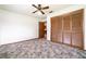 Bedroom with a ceiling fan and a large closet featuring bifold doors at 201 W New York Ave, Orange City, FL 32763