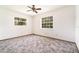 Bedroom with neutral walls, carpet and windows offering bright natural light at 201 W New York Ave, Orange City, FL 32763