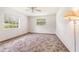 Bright bedroom featuring a ceiling fan, large windows, and a comfortable atmosphere at 201 W New York Ave, Orange City, FL 32763