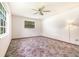 Bedroom with natural light, featuring a ceiling fan and neutral paint at 201 W New York Ave, Orange City, FL 32763