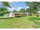 Charming single-story brick home with lush green lawn and mature trees at 201 W New York Ave, Orange City, FL 32763