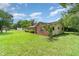 Charming exterior features lush lawn and mature trees at 201 W New York Ave, Orange City, FL 32763