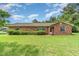 Beautiful home exterior enhanced with well-maintained landscaping and vibrant green lawn at 201 W New York Ave, Orange City, FL 32763