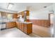 Kitchen featuring wood cabinets, and a view into the living area at 201 W New York Ave, Orange City, FL 32763