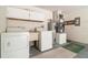 Functional laundry room equipped with washer, dryer, utility sink, and storage cabinets at 201 W New York Ave, Orange City, FL 32763