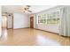 Open-concept living room featuring wood floors and large windows at 201 W New York Ave, Orange City, FL 32763