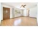 Bright living room featuring hardwood floors, front door and ceiling fan at 201 W New York Ave, Orange City, FL 32763