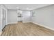 A serene bedroom features wood-look flooring and an adjacent bathroom at 223 Pinehurst Dr, Auburndale, FL 33823