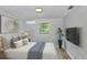 Comfortable bedroom with modern decor, a wall-mounted TV, and stylish accents at 223 Pinehurst Dr, Auburndale, FL 33823