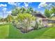 Charming home exterior with lush landscaping and green lawn at 223 Pinehurst Dr, Auburndale, FL 33823