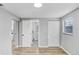 Hallway leading to bedroom and bathroom with closet and window views at 223 Pinehurst Dr, Auburndale, FL 33823