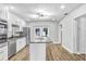 A well-lit kitchen features stainless appliances, white cabinetry and a functional center island at 223 Pinehurst Dr, Auburndale, FL 33823