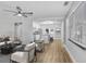 Modern living room area with sleek furniture, complemented by an open view into a stylish kitchen at 223 Pinehurst Dr, Auburndale, FL 33823