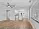 Open concept living space featuring updated flooring, leading into a bright kitchen area at 223 Pinehurst Dr, Auburndale, FL 33823