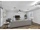 Bright living room with comfortable seating, a modern TV, and minimalist design at 223 Pinehurst Dr, Auburndale, FL 33823