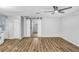 Open living room features new laminate floors, fresh paint, ceiling fan, and sliding barn doors at 223 Pinehurst Dr, Auburndale, FL 33823