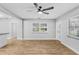 Open living area with a ceiling fan, a window, and luxury vinyl flooring at 223 Pinehurst Dr, Auburndale, FL 33823