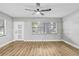 A bright living room offers an updated ceiling fan and natural light through window with blinds at 223 Pinehurst Dr, Auburndale, FL 33823