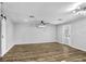 Minimalist living room with a modern ceiling fan and an outdoor view through a windowed back door at 223 Pinehurst Dr, Auburndale, FL 33823