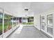 Relaxing screened patio with concrete floor, white beams, and view of backyard at 223 Pinehurst Dr, Auburndale, FL 33823